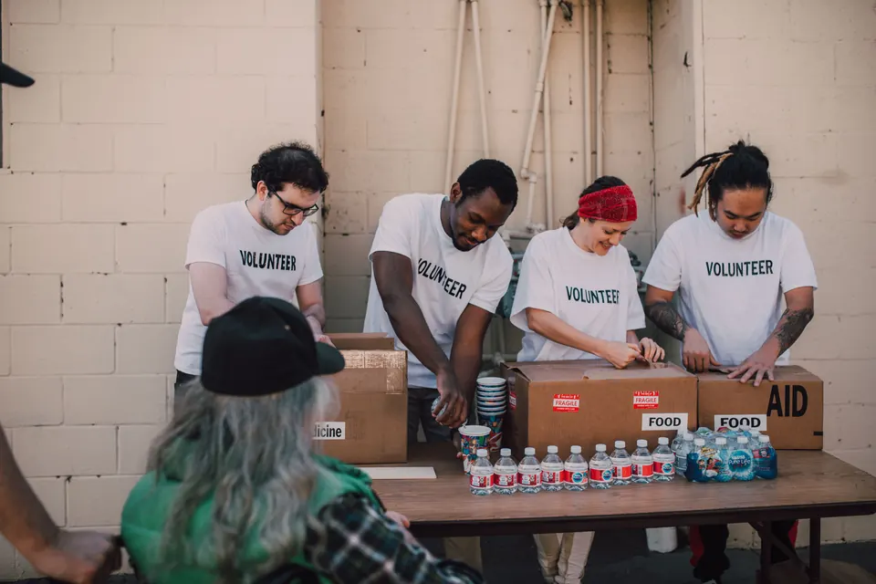 Volunteers preparing food aid boxes for distribution